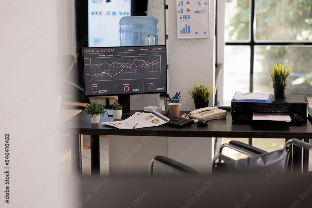 Poster interior of illuminated company workspace with desktop computer at the end of the work shift, office