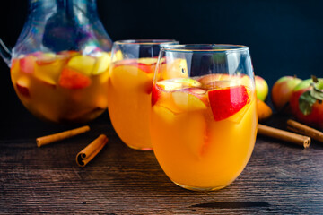 Glasses of Sangria With White Wine, Apples, Pears, and Cinnamon: Fall sangria flavored with fruit,...