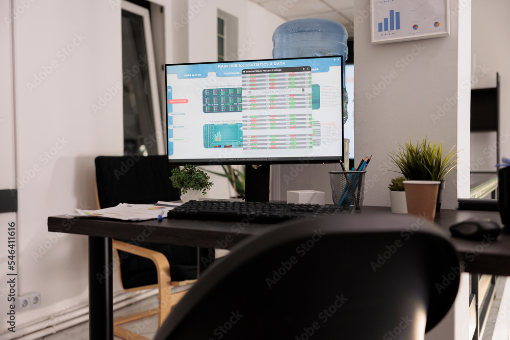 Poster computer screen on desk showing main software for cost analysis and financial results of the company