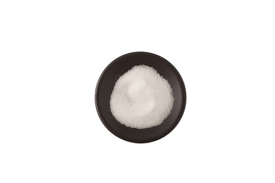 Stevioside, stevia sweetener in dark plate on white, top view. Food additive E960. Natural Extract found in the leaves of Stevia rebaudiana
