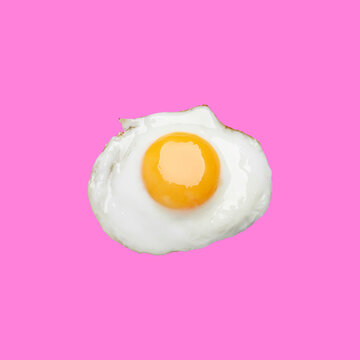 Tasty fried chicken egg on pink background, top view