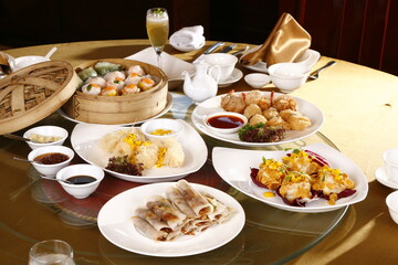 Various Chinese restaurant dishes placed on a table