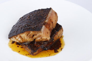 Closeup of baked salmon steaks in garlic butter