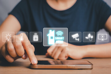 Smart home automation control system, Woman hand using smart phone with smart home control icon on...