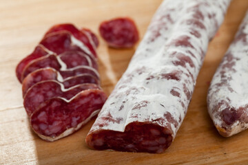 Slicing delicious Spanish smoked sausage fuete. High quality photo
