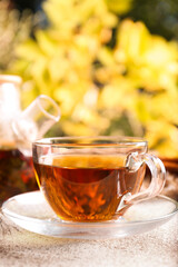 Hot tea on beige textured table outdoors, closeup. Autumn atmosphere