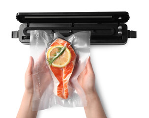 Woman using vacuum sealer on white background, top view. Salmon with lemon in pack