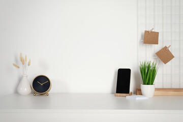 Comfortable workplace with white desk near wall at home