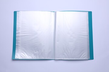 File folder with punched pockets and paper sheets isolated on white, top view