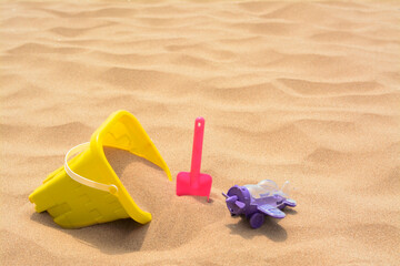 Fototapeta na wymiar Set of colorful beach toys on sand. Space for text