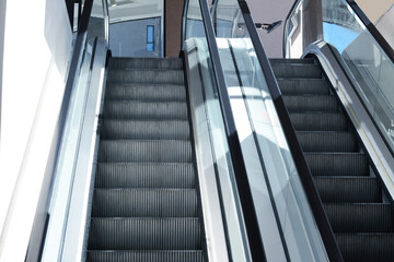 Naklejka premium Modern escalators with handrails in shopping mall