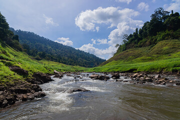 Khao Chong Lom Waterfall in the fresh green mountain. At Khun Dan Prakarnchon Dam, Nakhon Nayok Province, Thailand.
