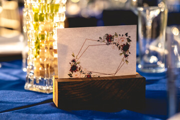 Table identification card in a wedding table with elegant table setting in the sunset