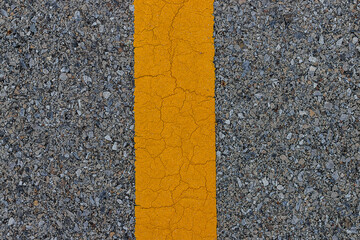 Background and texture of the road surface is  small stones and yellow lines on asphalt.