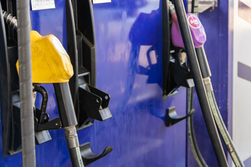 Close up nozzle fuel for fill oil into car tank at pump gas station,