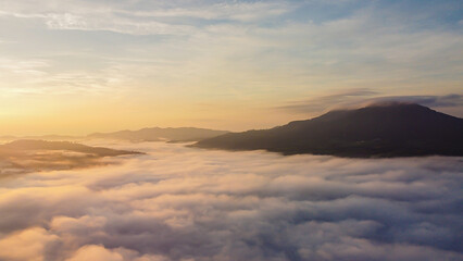 Thick fog in the mountains at dawn, Beautiful  sunrise and fog landscape.