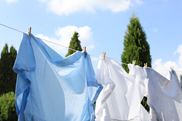 Clean clothes hanging on washing line outdoors. Drying laundry