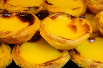 Portugal's traditional sweet dessert Pastel de nata egg custard tart pastry served with view on display in bakery, Lisbon area, Portugal