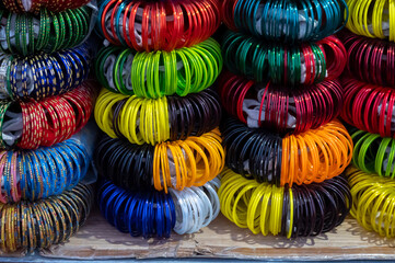 Fototapeta na wymiar Colorful Rajasthani bangles being sold at famous Sardar Market and Ghanta ghar Clock tower in Jodhpur, Rajasthan, India.