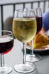 Drinking of red and white Portuguese wine in outdoor cafe at view point on old part of Lisbon city, Portugal