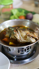 Pindang patin, pangasius fish in pindang soup. cooked in salt and spices including tamarind juice, garlic, shallot, ginger, turmeric, lemongrass, chili pepper, Indonesian bayleaf, citrus leaf