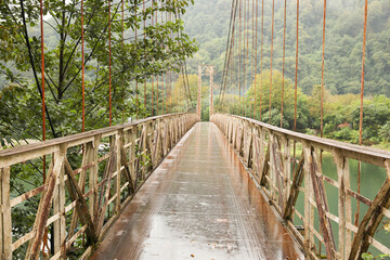 Fototapeta premium Beautiful view on rusty metal bridge over river in mountains