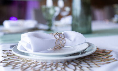 Fototapeta na wymiar Serving and decoration of the wedding table. Glasses, spoons, forks and white napkins