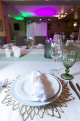 
Serving and decoration of the wedding table. Glasses, spoons, forks and white napkins