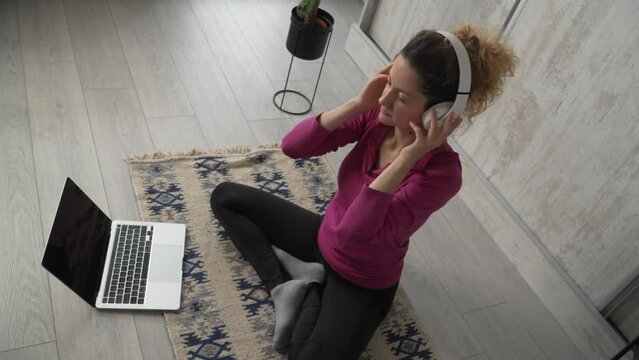 one woman doing guided meditation yoga self care practice at home