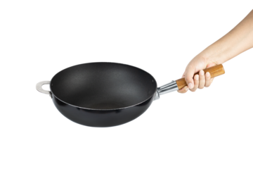 Hand holding cast iron pan with wooden handle isolated on white background with clipping path.