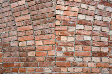 Clean masonry work in an old brick wall, as a patterned and weathered background
