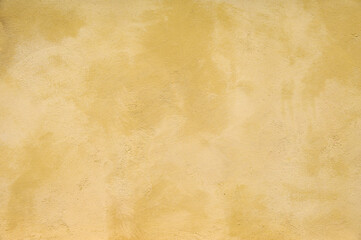 Obraz na płótnie Canvas Textured wall in shades of yellow paint, as a graphic background 