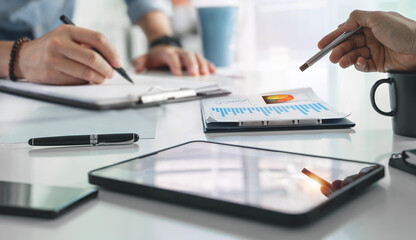 Cropped shot of Professional business partner consulting the strategy, using digital tablet and graph chart at office.