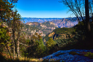 natural landscape mountains and hills in the background  with river in the shadow and pines around in the sierra madre occidental mexiquillo durango 