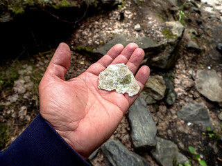 piece of transparent mica in the hands of a man