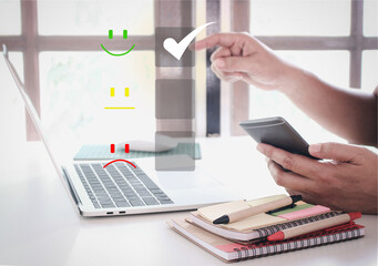 Customer service check concept and satisfaction ,Business people are touching the virtual screen on the happy Smiley face icon to give satisfaction in service. The rating very impressive.