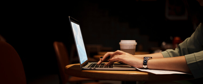 Close Up Hand Asian Woman Holding Pen In Casual Clothes Working In Cafe With Laptop.