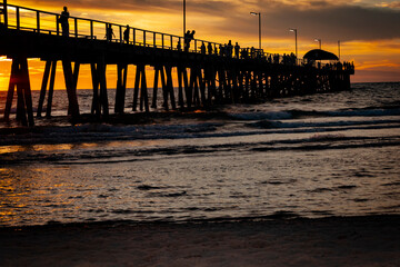 The Grange jetty in Adelaide on a beautiful dusk evening with calm waves hitting the beach...