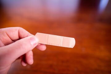 using a band aid on a hand