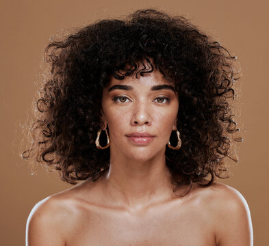 Portrait, skincare and black woman in studio for hair, skin and beauty, grooming and hygiene on brown background. Face, wellness and girl model with natural, afro and glam cosmetic with makeup