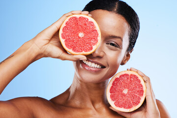 Black woman, fruit and smile in healthy skincare holding grapefruit for nutrition against a blue...