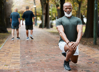 Senior african man, stretching and park with focus for fitness, wellness and exercise on ground. Elderly black man, lunge and leg workout, training or muscle development in street for body health - obrazy, fototapety, plakaty