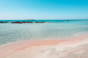 Elafonisi, crete island, greece: pink colored sandy beach with black rocks at the famous cretan...