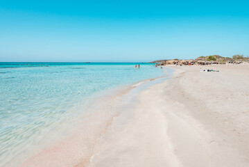Elafonisi, crete island, greece: pink colored sandy beach with black rocks at the famous cretan...