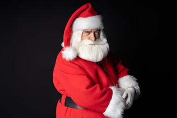 Santa Claus doubts your abilities. Concept idea to evoke feelings. Portrait on a black background.