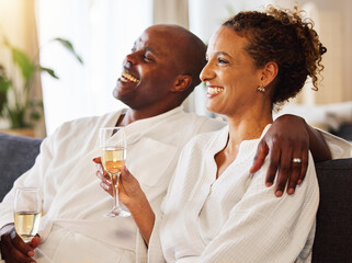 Black couple, champagne and spa therapy on a couch to relax, celebrate and feel zen while together...