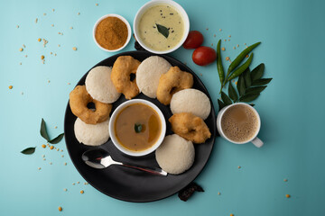Obraz na płótnie Canvas south indian food called idli vada sambar or sambar vada or wada, served with coconut chutney and south indian style hot coffee