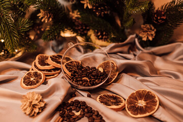 Christmas composition with coffee beans, dried oranges and garland