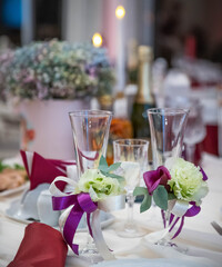 wedding decorations. wedding glasses. champagne glasses decorated with flowers and ribbons. wedding banquet. romantic dinner in a restaurant