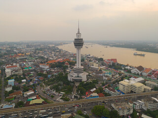 Fototapeta na wymiar Aerial top view of observation deck viewpoints tower, Samut Prakan urban city town skyline view. Sightseeing exploring city skyline in travel on holiday vacation. Thailand.